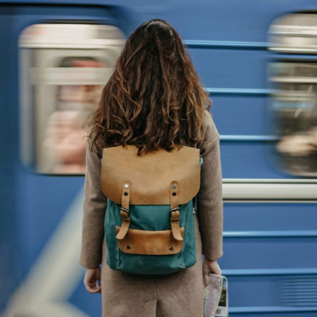 young-woman-girl-traveller-in-front-of-train-in-me-2024-10-18-04-29-46-utc